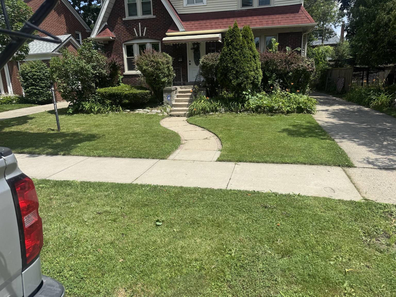 Freshly maintained lawn and landscaping by B&J Lawn Care
